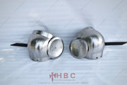Two pieces of hand-forged medieval elbow cop armor with side rondels attached, lying on a white surface.
