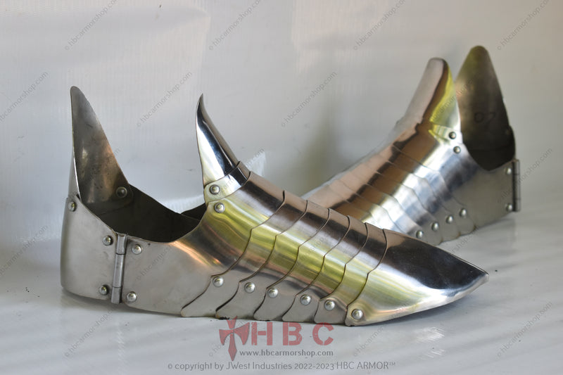 A pair of hand-forged Gothic 15th century sabaton foot armour designed for historical reenactment and medieval combat sports.