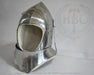 A polished steel medieval helmet with a padded off-white interior lining, displayed on a white surface against a white background with a faint HBC logo watermark.