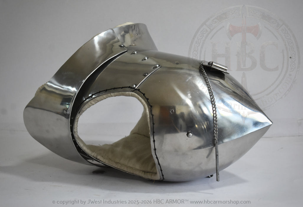 A polished steel medieval-style helmet or visor with a pointed tip, rivets, and a chain detail, photographed on a light gray background with a faint HBC Armor watermark.