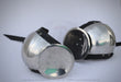 Two polished steel medieval round helmets with black padded undercaps and straps, displayed on a light gray background.