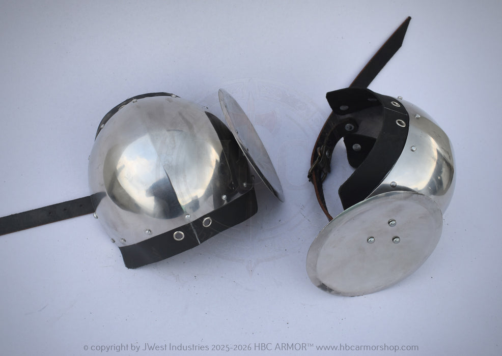 Two medieval-style steel helmet visors with black leather straps, displayed on a light gray background. One visor is shown closed and the other is shown open to display the internal structure and spike.