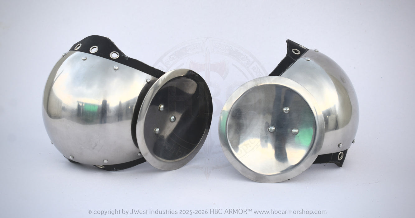 Two polished steel glomerin armor helmets with black leather straps and rivets, displayed side-by-side on a white background.