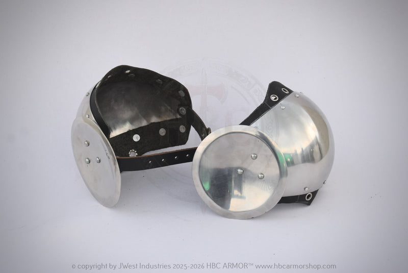 A pair of medieval-style steel gorgets with black leather straps, displayed on a light gray background.