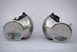 A pair of vintage-style metal arm guards with circular silver steel plates and black adjustable straps, displayed on a light gray background.