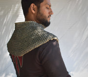 A person wearing a padded chainmail collar with a visible intricate pattern of flat riveted rings, designed for medieval reenactment or costume creation.