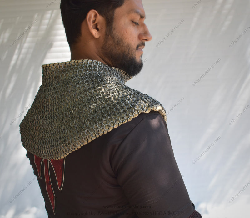 A person wearing a padded chainmail collar with a visible intricate pattern of flat riveted rings, designed for medieval reenactment or costume creation.