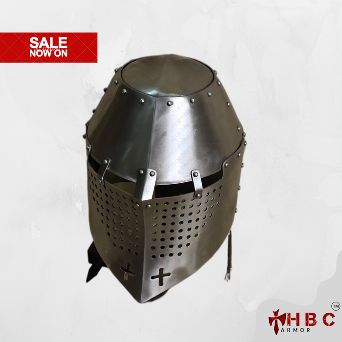 A medieval-style steel helmet with a pointed conical top, eye slits with ventilation holes, and a cross emblem on the front, shown on a light gray background with a red 'SALE NOW ON' banner in the top left and an HBC Armor logo in the bottom right.