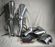 A set of medieval European style armor including pieces for the arms and legs, featuring pauldrons, thigh armour, and shin guards.
